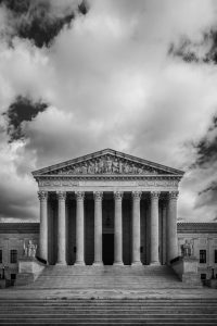 A black-and-white image of the clouds over the U.S. Supreme Court building.