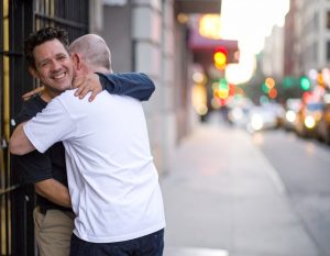 Friends greet each other after one of them got out of jail.